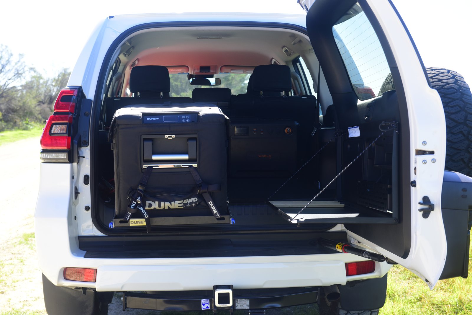 Vehicle and Camping Gear Dune 4WD fridge installed in the rear of the Prado, on its custom slide