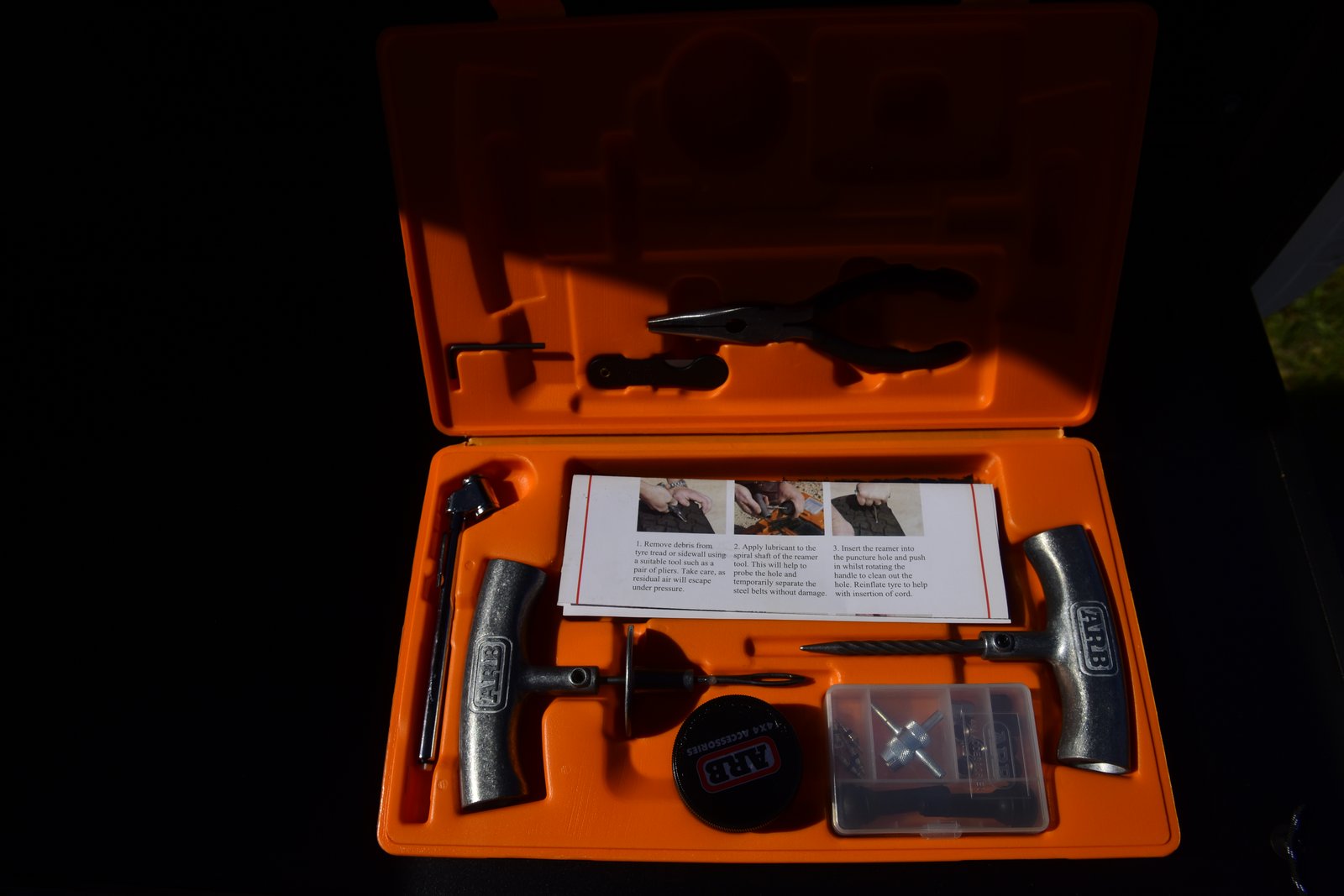 Vehicle and Camping Gear Open orange ARB tyre repair kit case showing reamer, plug tool, plugs, lubricant and pliers