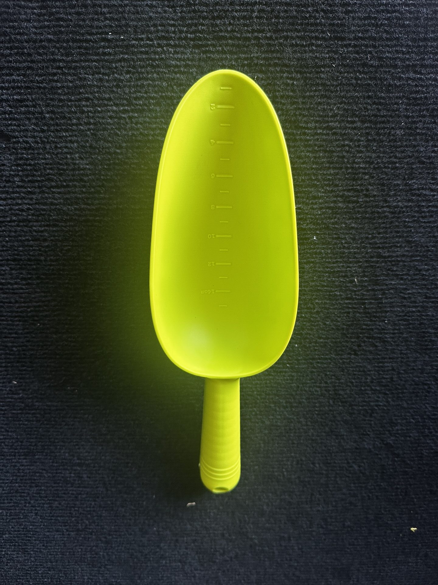 Prospecting Gear Green plastic prospecting nugget scoop standing upright